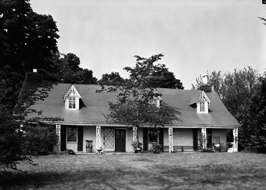 Clear Comfort, Alice Austen’s house, photographed for the Historic American Buildings Survey: a low white cottage with three gabled dormers behind a lawn.