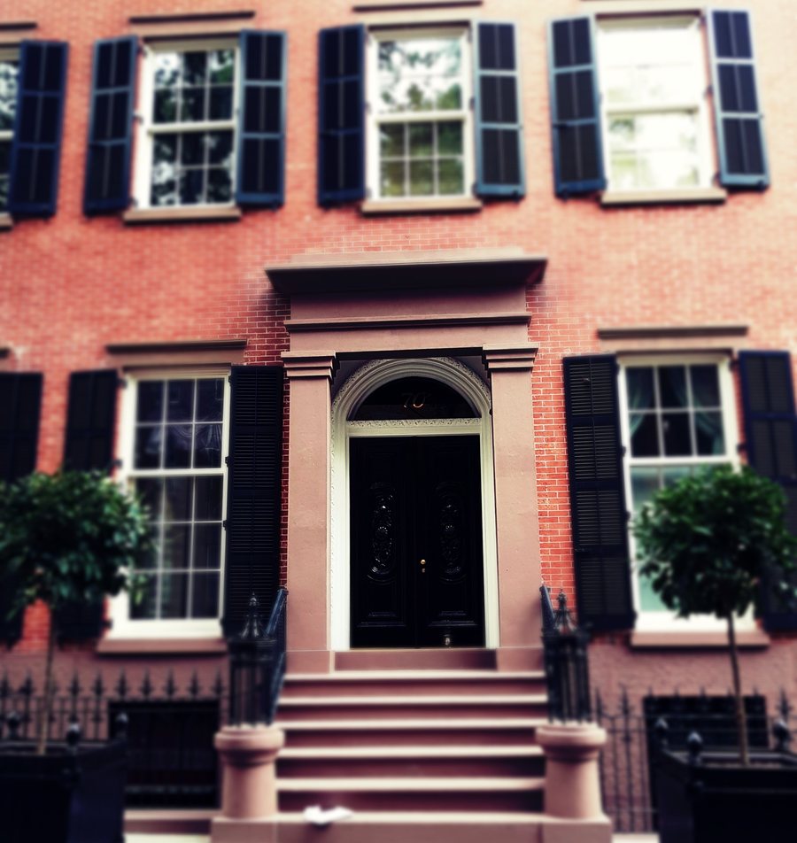 The front door of 70 Willow Street in 2018, shuttered windows either side and a stoop between two small trees.